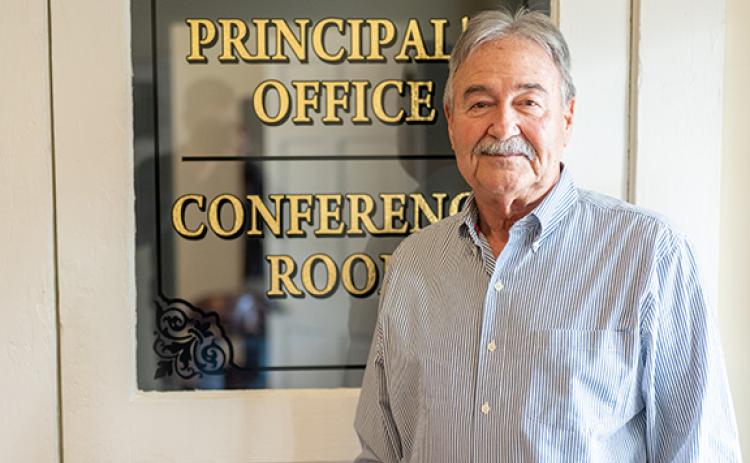Mayor Ray McAllister stands in front of the principal’s office door of the old schoolhouse, now his office and town hall. (Zach Taylor/Staff)