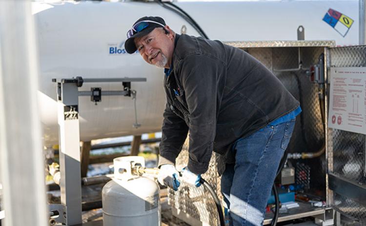 Paul Shirley, “The Propane Man,” fills up propane tanks with ease after helping distribute more than 8,000 gallons of propane at Ace Hardware in Cornelia over the past two weeks. (Zach Taylor/Staff)