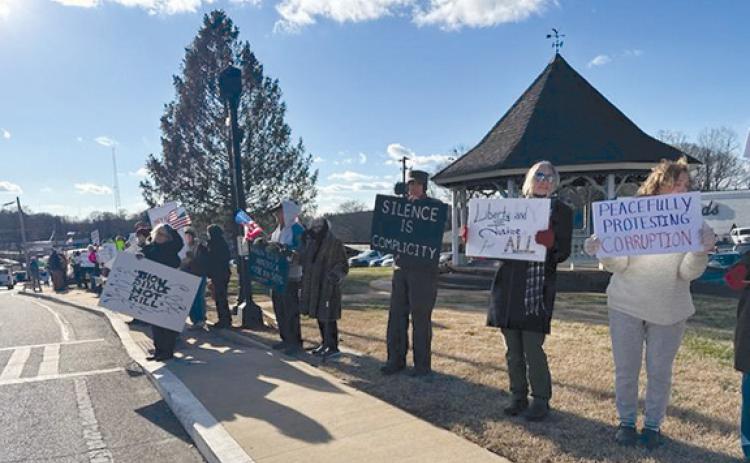 People waved signs focused on prominent issues in downtown Clarkesville Thursday. (Submitted)