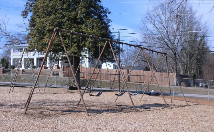Two old sets of swings sit vacant on the Baldwin  Elementary School playground, waiting for children to fill its seats. The swings could see a potential upgrade with the possible approval of ESPLOST VII by county voters. (Hannah Caudell/Staff)