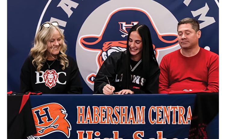 Raegan Turner, Habersham Central senior Eden Turner and Ken Turner sit together during the signing ceremony. (Submitted)