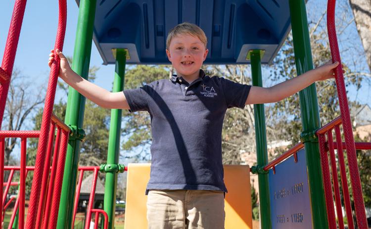 Price Herrin, the inspiration of Price to Play, plays on the current playground in Demorest. (Zach Taylor/Staff)