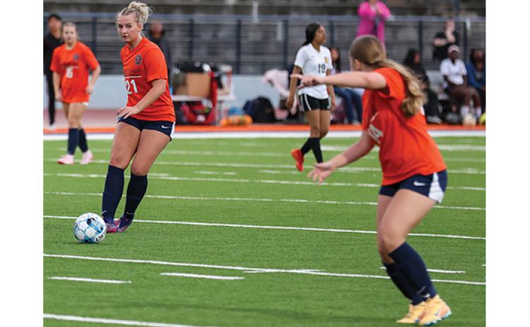 Habersham Central senior Maddox Carroll (21) passes the ball to sophomore Bailee Maney (14) during a soccer match between Alcovy and Habersham Central at Raider Stadium on March 6. (Landen Todd/Staff)