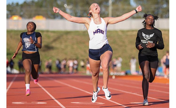 Habersham Central track and field athlete Kaylan Barrett, center, celebrates during a home meet at Raider Stadium on Tuesday, March 24. (Landen Todd/Staff)