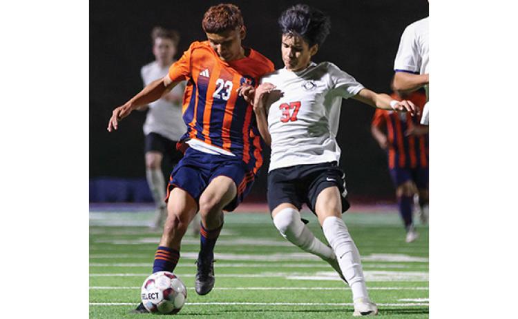 Habersham Central sophomore Arnol Hernandez (23) fights for the ball during a soccer match between Winder-Barrow and Habersham Central at Raider Stadium on Friday, March 20. (Landen Todd/Staff)