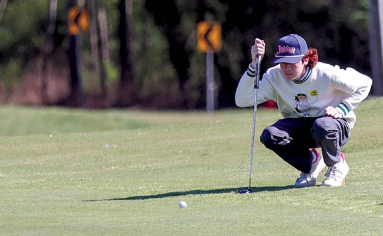 Habersham Central junior golfer Tristan Farr prepares to putt the ball. (Landen Todd/Staff)