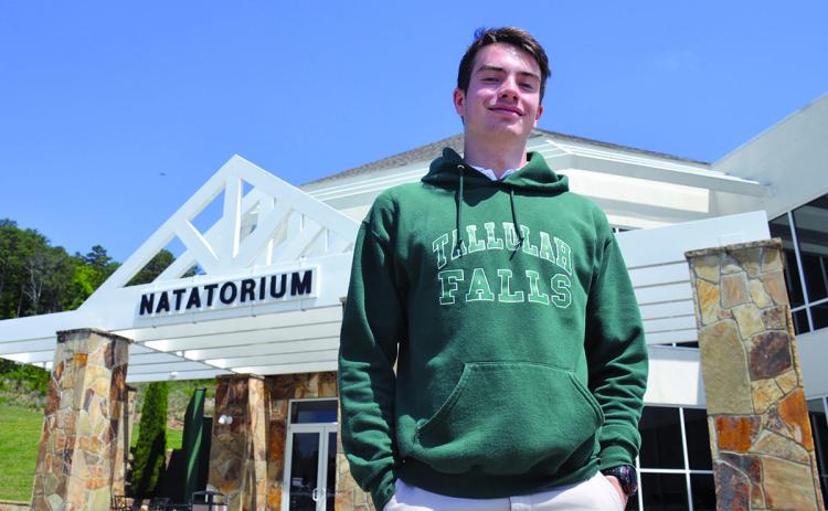 Caden Polley stands outside his home away from home, the TFS Natatorium.