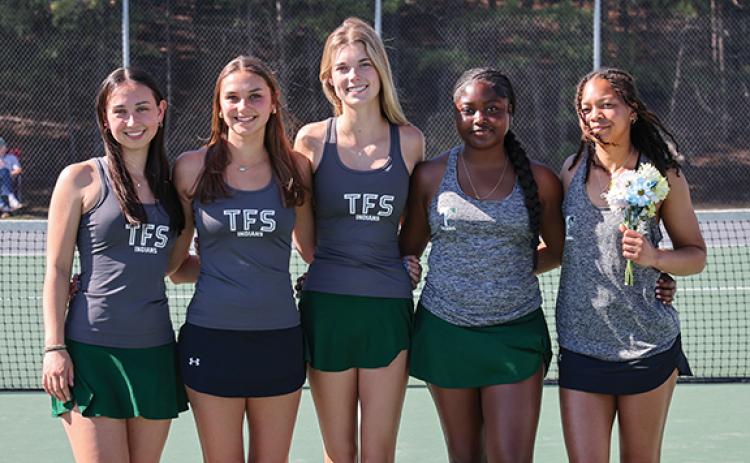 Left to right, seniors Charlotte Stafford, Keira Webb, Ava Carnes, Azaria Junaid and Jaeda-Lee Daniel-Joseph smile for a photo on the tennis court. (Submitted)
