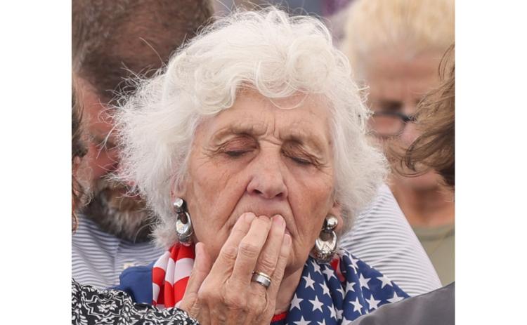 Myrna Fouts places her fingertips on her lips as she prays during National Day of Prayer at Donald Anderson Park in Cornelia on Thursday. (Landen Todd/Staff)