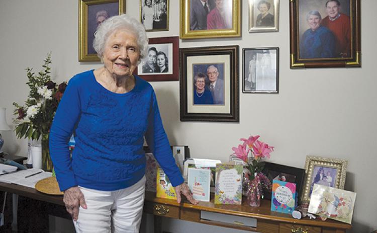 Mary Lou Martin stands in front of family photographs and birthday cards she received. (Samantha Sinclair/Staff)