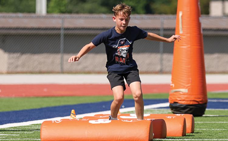 Camper Jacob Barnett shows off his skills during the HCHS football youth camp at Raider Stadium. (Landen Todd/Staff)