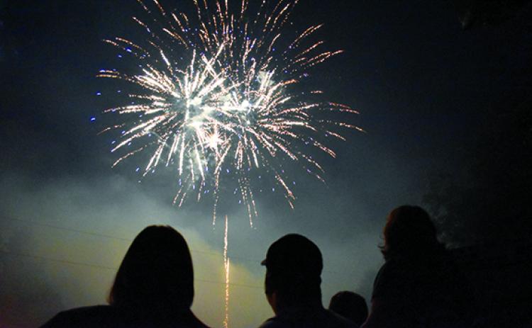 Fireworks explode high above the ballfield as firefighters and their families got front row seats to the show at Demorest’s Glorious Fourth of July last year. (Samantha Sinclair/Staff)