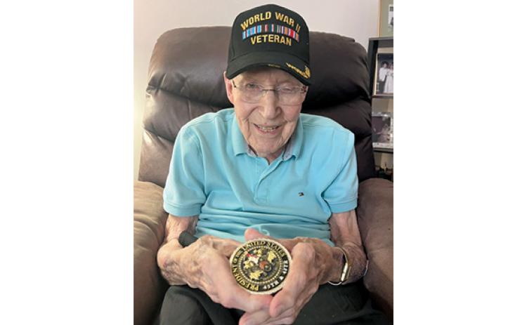Capt. Ken Schubring Sr. holds the challenge coin President Donald Trump presented to him on July Fourth. (Submitted)