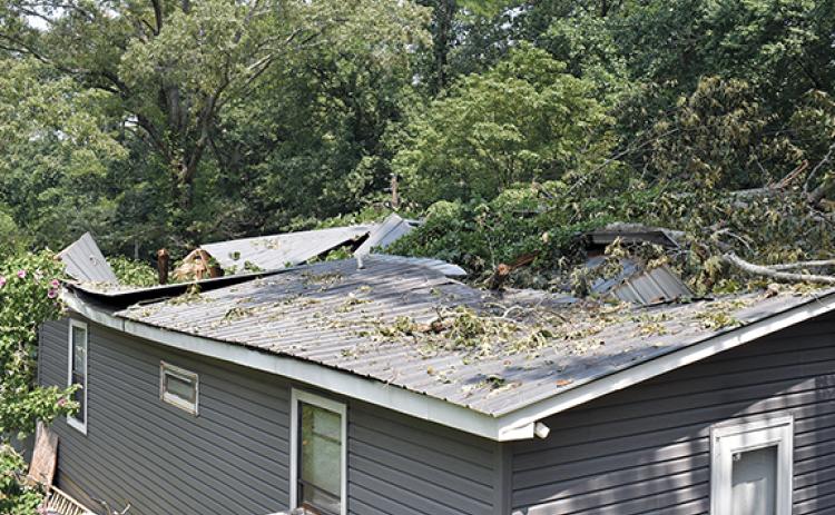The home of Bernard Trimiar suffering from a collapsed roof as a result of Tuesday’s storm. (Noah Ansley/Staff)
