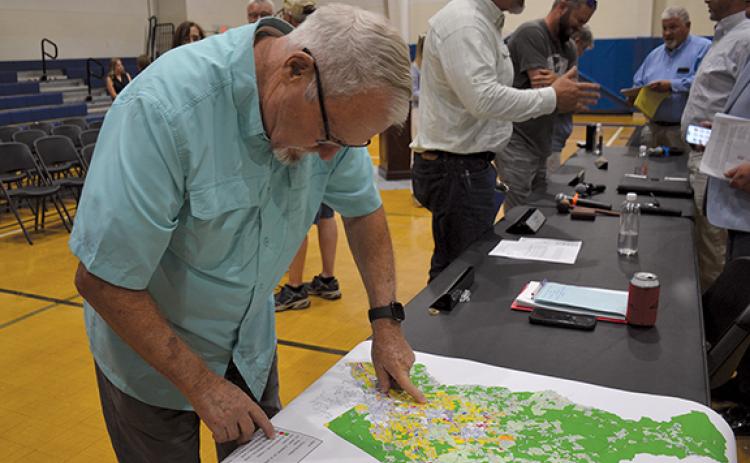 Jimmy Dean looks over the proposed zoning map for the Unified Development Ordinance following the town hall on June 4. (Samantha Sinclair/Staff)