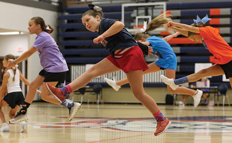 CHS cheer camper Everly Nicolson runs during a game of Duck, Duck, Goose during the cheer camp at the Raider Gymnasium on Wednesday, July 8. (Landen Todd/Staff)