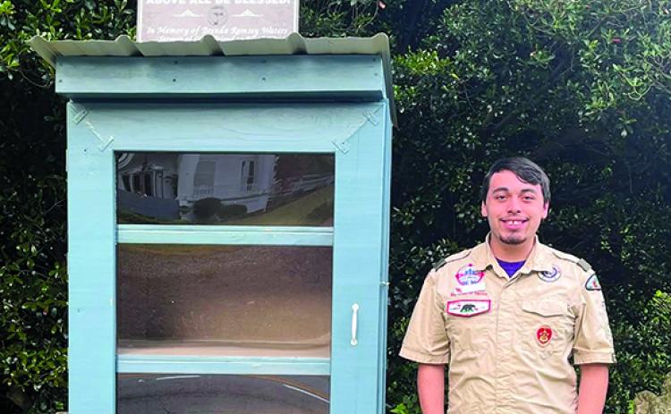Eagle Scout Adam Moore poses at the food donation box he rebuilt at Clarkesville First Methodist Church for his Eagle Scout project. (Submitted)