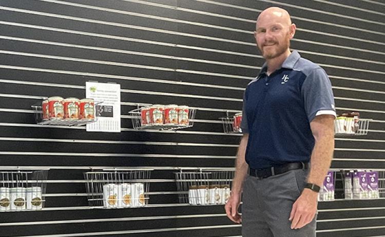 Habersham Central High School Principal Dr. Adam Bagwell stands amongst some of the offerings in the new Raider Food Mart, a food bank for all students to enjoy starting Aug. 7. (Submitted)
