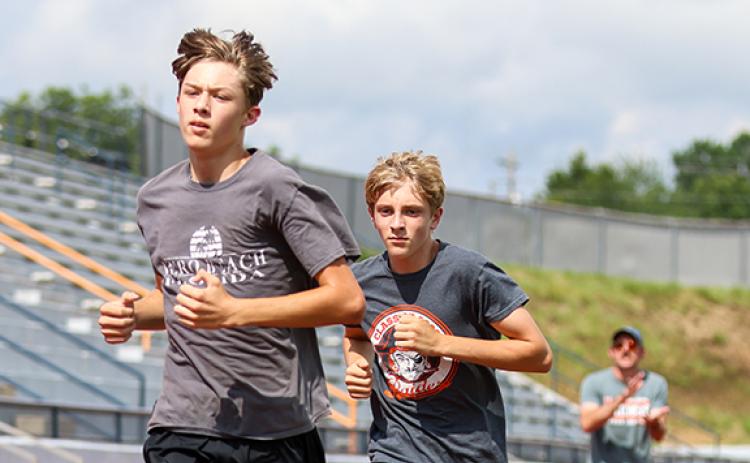 Habersham Central harriers Jadyn Recor and Peter Grieving in action during the cross country practice at Raider Stadium on Thursday, Aug. 6. (Landen Todd/Staff)