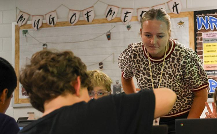 PresLee Hix, an English Language Arts co-teacher at South Habersham Middle School, helps one of her students with an assignment during class Wednesday. (Hannah Caudell/Staff)