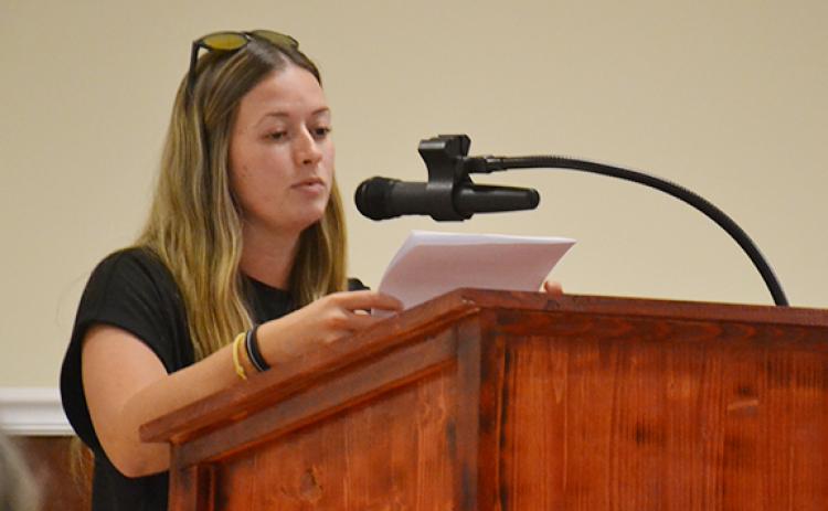 Sydney Blackburn shares her concerns about the rezoning of 45 acres from the county's Suburban Residential to Baldwin's Highway Business during a second public hearing on Cook Construction's request Tuesday night. (Samantha Sinclair/Staff)