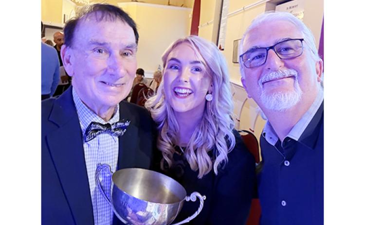 Don Gnecco, Saoirse Scully and Pat Marnane take a photo with the Perpetual Cup after an award-winning performance at the 2026 International Song of Peace contest. (Submitted)