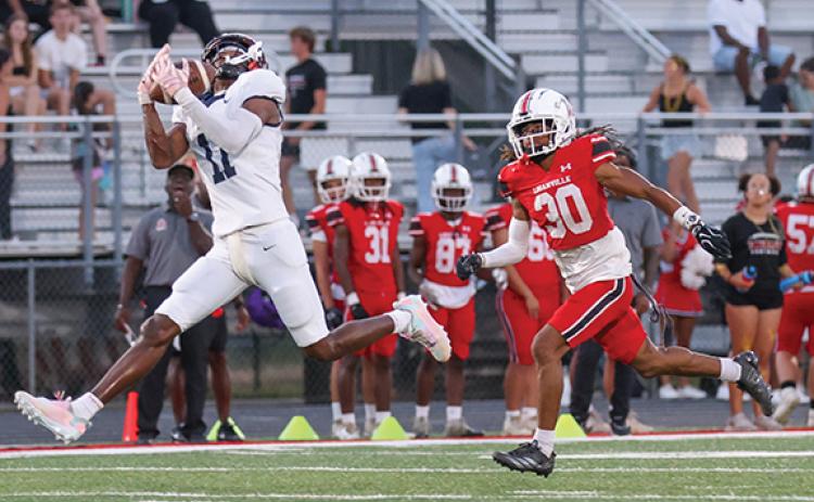 Habersham Central senior wide receiver Jay Feltus (11) catches the ball and takes it to the house during a high school football game between Habersham Central and Loganville at Red Devil Stadium on Friday, Sept. 18. (Landen Todd/Staff)