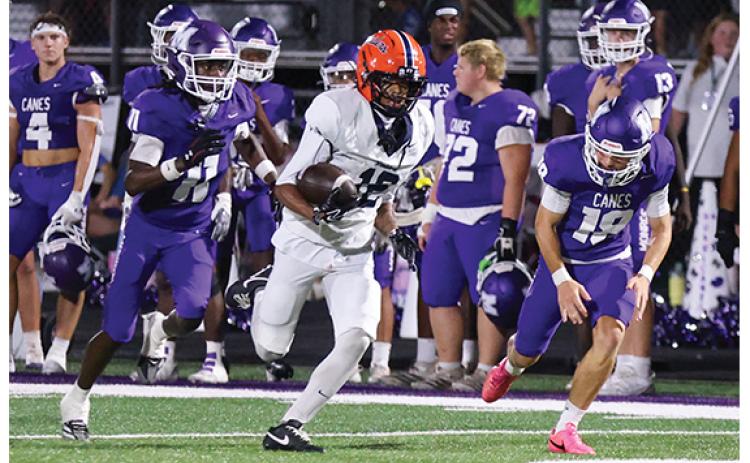 Habersham Central senior wide receiver KJ Murray (12) returns the kick off during a football game between Habersham Central and Monroe Area at the Purple Pit on Friday, Sept. 4. (Landen Todd/Staff)