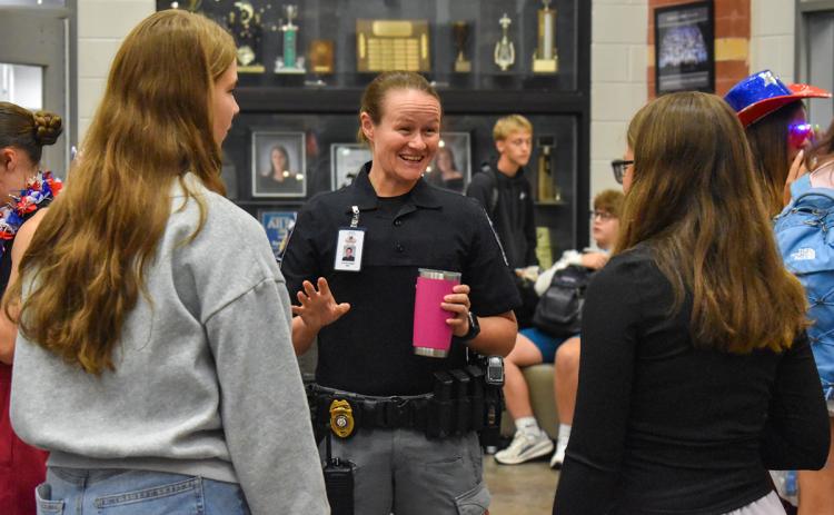 Habersham Central School Resource Officer Victoria Hopper (middle) converses with students before the 8 a.m. bell rings on Thursday morning. (Hannah Caudell/Staff)