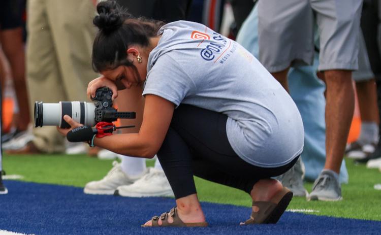 Habersham Central High School senior Oaklee Jackson tries to get a different angle for a photo during a Raider Football game. (Landen Todd/Staff)