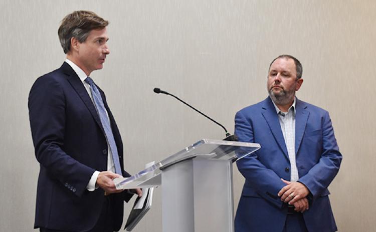 Andrew Tritt (left), managing director at brokerage and investment banking firm Stifel, Nicolaus and Company Inc., thanks the board for working with the company as they prepare to vote for a bond sale agreement for the playground project while Superintendent Patrick Franklin looks on. (Hannah Caudell/Staff)