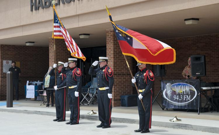 Jamie Tyler, Shawn McClure, Randi Seabolt and Kyle Shelton of the Last Call Honor Guard present the colors for the Pledge of Allegiance at the Shop with a Hero Benefit Car Show in May. (Samantha Sinclair/Staff)