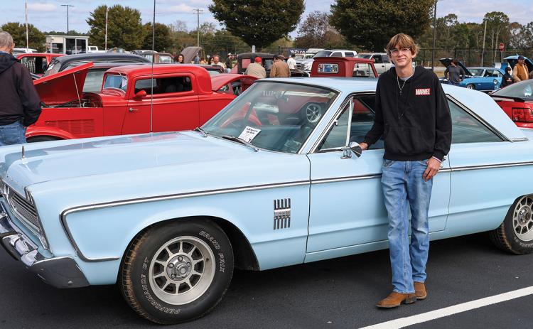 Clarkesville native Zac Bonner poses with his 1966 Plymouth Fury III during the L3R Memorial Foundation car show at Habersham Central High School on Saturday, Oct. 24. Bonner was a top-ten winner. (Landen Todd/Staff)