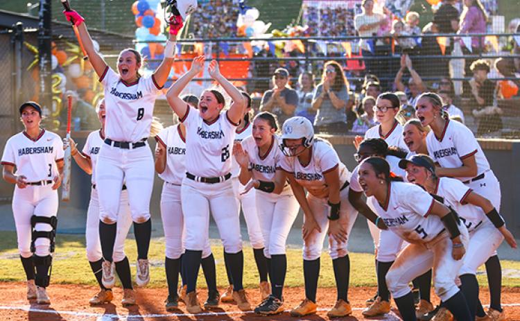 Habersham Central players celebrate Brinkley Gilleland’s home run during a softball game from this past season. (Landen Todd/Staff)