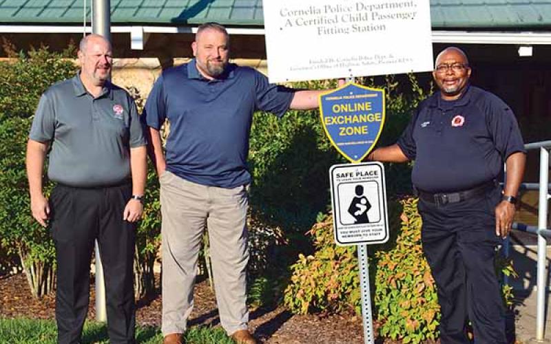 Shown with one of the new “safe haven” signs, located at the Cornelia Police Department, is, from left, City Manager Donald Anderson, Police Chief Chad Smith and Fire Chief Billy Jenkins Jr. (Photo/CHRISTINA SANTEE)