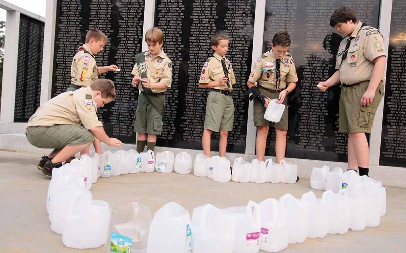 Boy Scouts Troop 106 of Homer and Troop 5 of Clarkesville help with the candlelight vigil at the Habersham County Veterans Wall of Honor, Cornelia. The ceremony paid respects to the victims of the 9/11 terrorist attacks. Shown, from left, are Samuel Hattaway, Matthew Owens, Caleb Crump, Mitchell McGahee, Joseph McGahee and Cameron Mote. (Photo/ERIC PEREIRA)