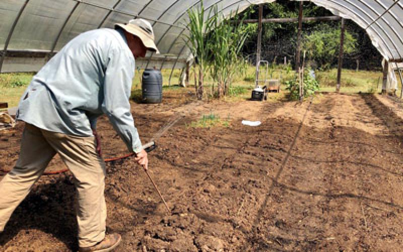 Daniela Cintron/ Chuck Mashburn works the soil
