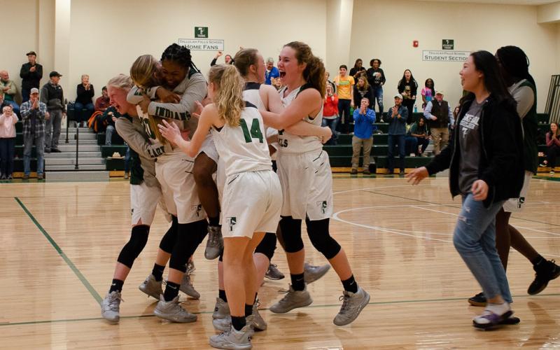 The Lady Indians celebrate after beating Paideia High School 51-50 in the first round of the Georgia High School Association state basketball tournament Friday.