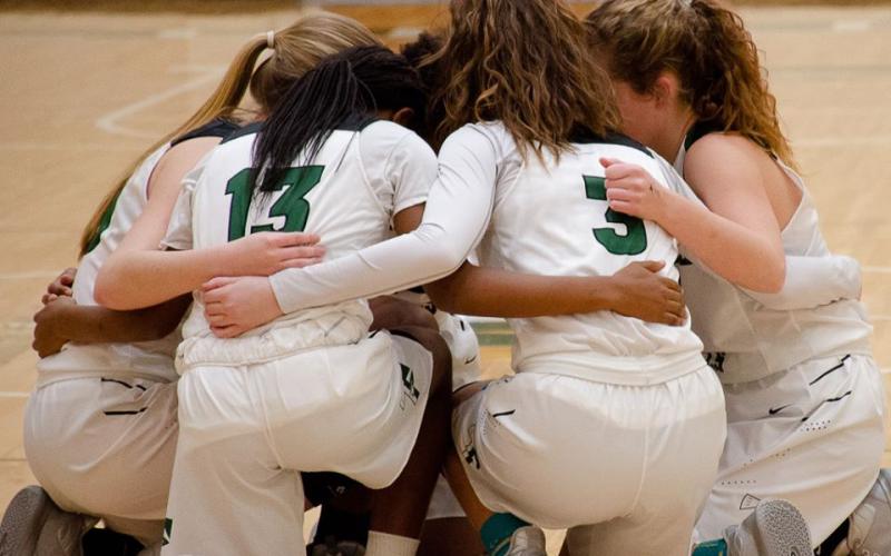 The Lady Indians huddle together before their game against Paideia High School in the first round of the Georgia High School Association state basketball tournament Friday.