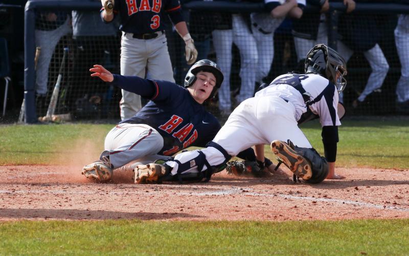 Habersham Central’s Christian King (10) slides into home plate during the Raiders’ 6-3 win over White County High School Saturday in Cleveland.