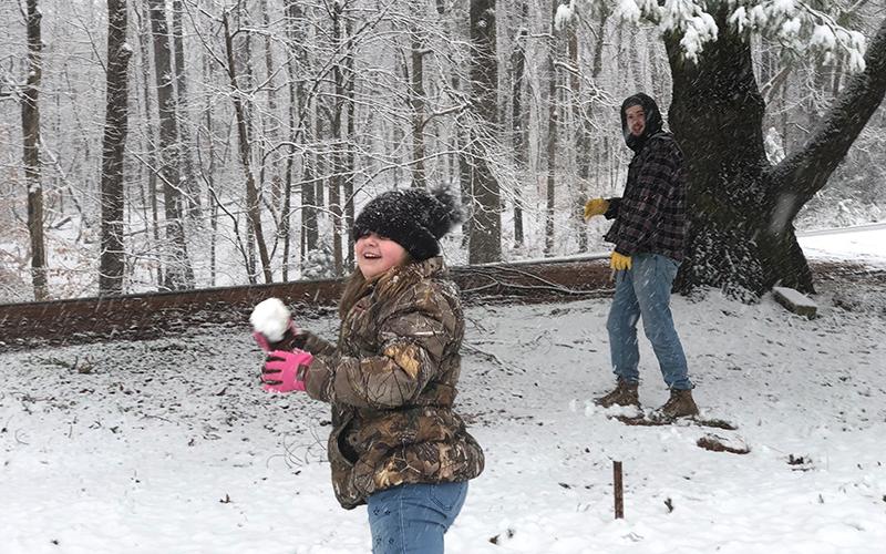 Shelby Rogers (left) and Morgan Gailey (right) of Baldwin prepare for a snowball fight during the snow storm on Saturday.