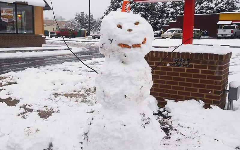 Sue Beeso helped her son and a friend build the “Popeye’s winter mascot” on Saturday afternoon in Cornelia. He is sporting chicken livers for the eyes and nose and nuggets for the mouth.