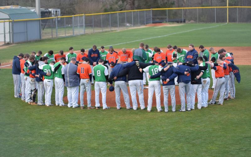 Members of the Habersham Central and Franklin County high school baseball teams pray for Raider Hadden Carswell before their game Friday. Carswell was seriously injured in an automobile accident Feb. 24.