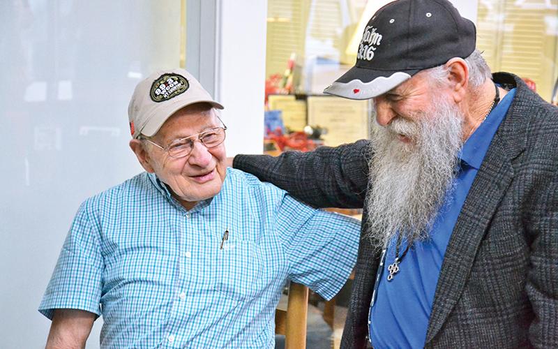 Billy Burrell (left) shares a laugh with John A. Harris at his birthday party on Friday morning.