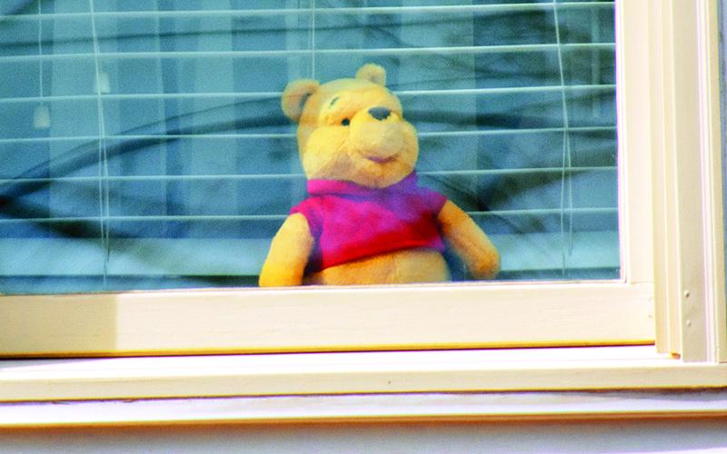 Winnie the Pooh waits to be found in this window on Grand Avenue in the Tower Mountain neighborhood in Cornelia.