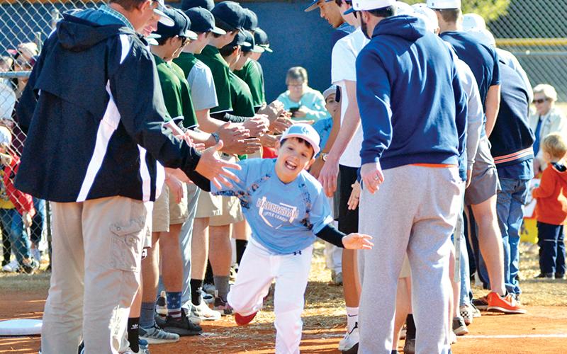 Easton Martin high-fives Tallulah Falls School and Habersham Central High School players during HCLL Opening Day in 2019.