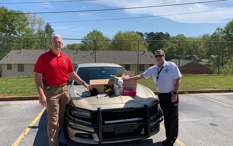 Emergency Services Director Chad Black (right) helped supply Sheriff Joey Terrell’s Office with 295 N-95 masks from the Department of Public Health.