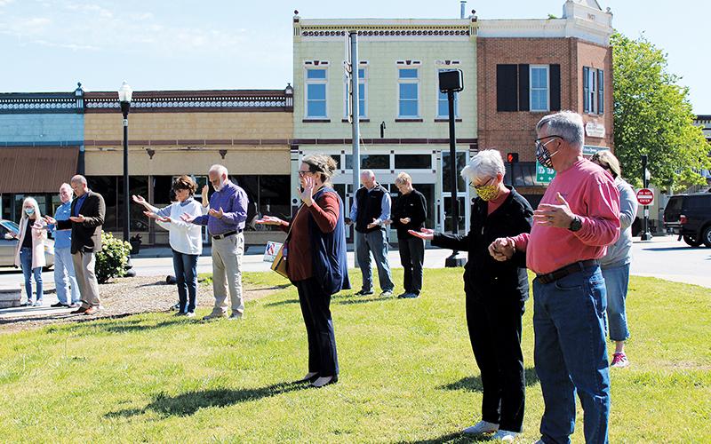 Residents pray in the Clarkesville downtown square during their city’s portion of the National Day of Prayer festivities. Photo by ISAIAH SMITH/Staff