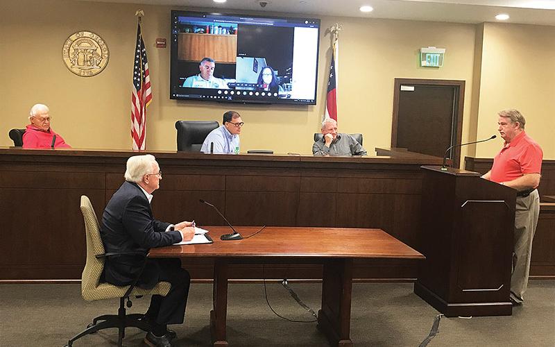 County Manager Phil Sutton (bottom left) along with Commissioners Jimmy Tench, Stacy Hall and Tim Stamey (from left on bench) listen to Banks County Fire Chief Steve Nichols discuss radio systems on Monday morning.