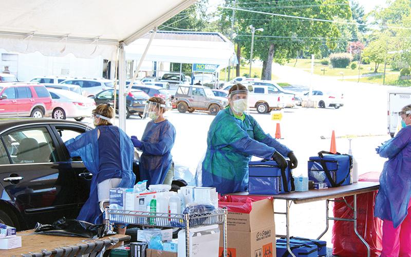 Healthcare workers test patients at a drive-thru COVID-19 event on June 13 in Cornelia. Photo by ISAIAH SMITH/staff